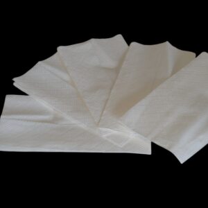 A stack of white paper napkins on a black background.