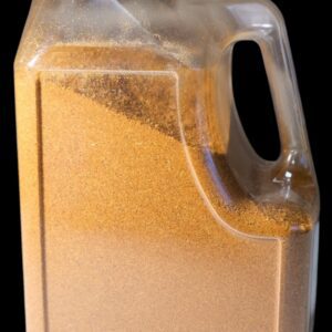 A clear plastic container filled with a light brown granular substance.