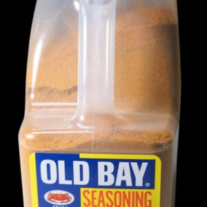 A bottle of Old Bay seasoning with a clear handle and yellow label.