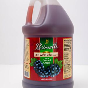 A bottle of Pastorelli red wine vinegar with grape imagery on the label.