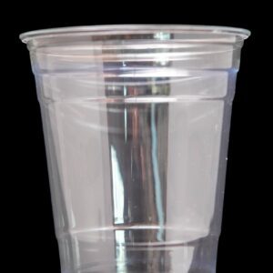A clear disposable plastic cup against a black background.