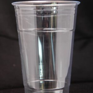 A transparent plastic cup on a dark background.