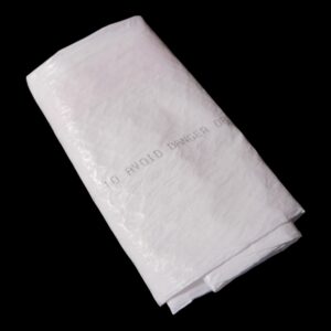 A neatly folded white towel against a black background.