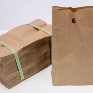 Stack of brown paper bags with a single bag marked number 6.