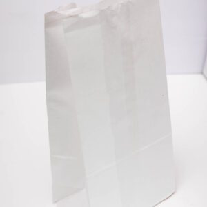 A plain white paper bag standing upright on a white surface.