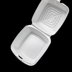 Open white foam takeout container on black background.