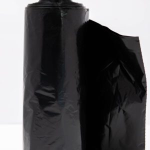 A roll of black plastic trash bags with one bag partially unrolled.