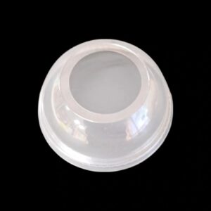 White plastic lid with a circular opening on a black background.