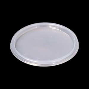 A clear, round plastic lid on a black background.
