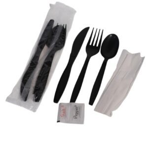 Black plastic cutlery set with napkin and salt packet in clear packaging.