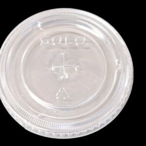 Clear plastic lid with a drinking hole on a black background.